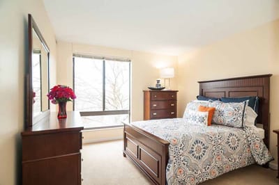 Cozy bedroom with a large window and decorative bedding