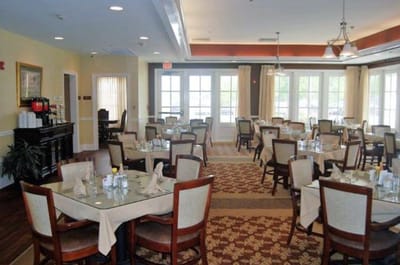 Dining room setup with tables and chairs