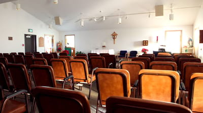 Interior of a quiet chapel with empty chairs