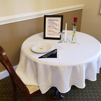 Table setting for a dining experience with a rose.
