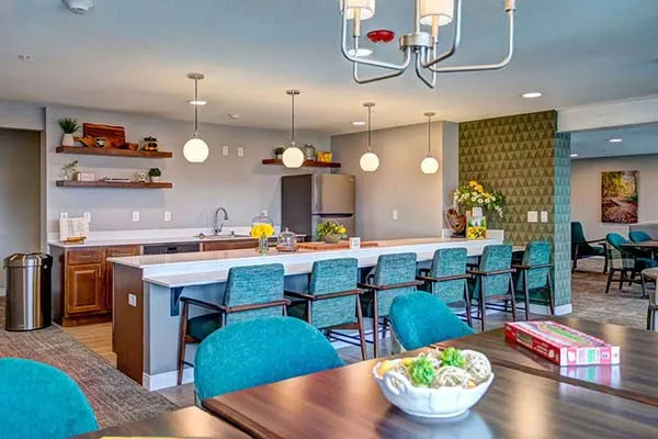 Bright communal kitchen area with dining space