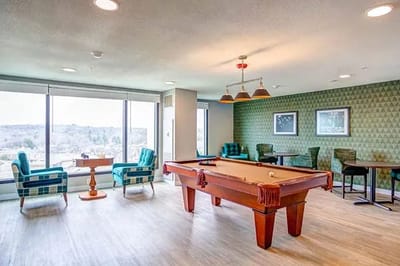 Common area with a pool table and seating