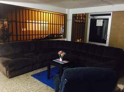 Cozy common area with a large sofa and flowers