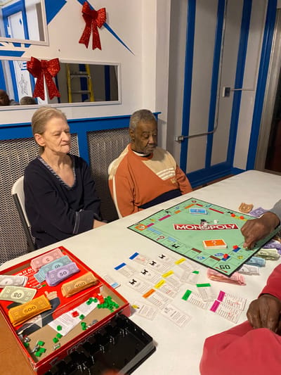 Residents playing Monopoly in a common area