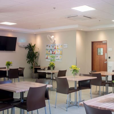 Bright dining room with tables and flowers