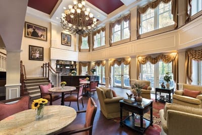Common area in a senior living facility with a chandelier