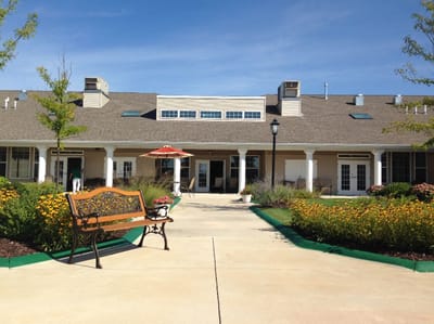 Exterior view of Lincolnshire Place with flowers and seating