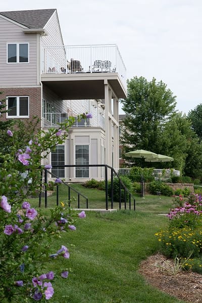 Exterior view of a senior living facility with landscaped garden