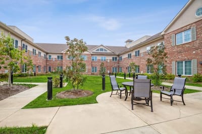 Outdoor courtyard with seating in a senior living facility