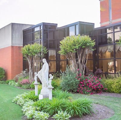 Well-maintained garden area with a statue near the facility