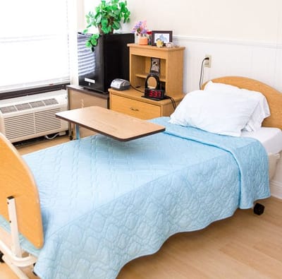 A cozy resident room with bed and furniture