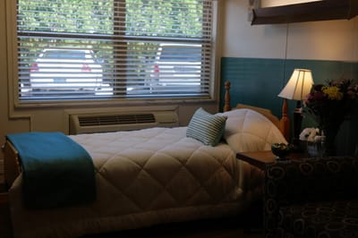 Cozy resident room with bed and flowers