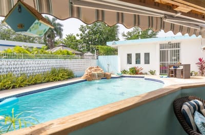 A tranquil outdoor pool area with greenery