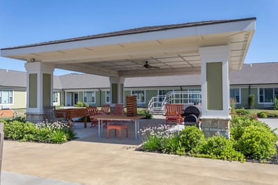 Outdoor seating area with plants and tables