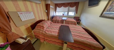 Cozy resident room with two beds and a TV