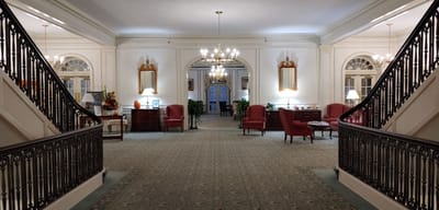 Elegant lobby area with grand staircase and seating