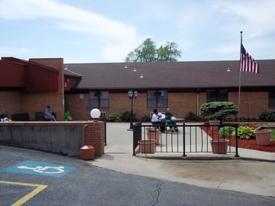 Exterior view of a senior living facility with residents