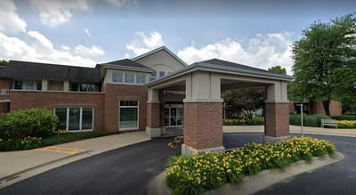 Entrance of a senior living facility with flowers