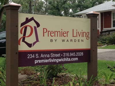 Sign displaying Premier Living by Warden