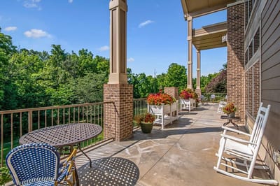 Outdoor patio area with seating and greenery
