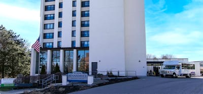 Exterior view of Renaissance Senior Living with a facility shuttle