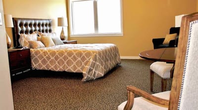 Cozy interior of a resident room with a bed and seating area