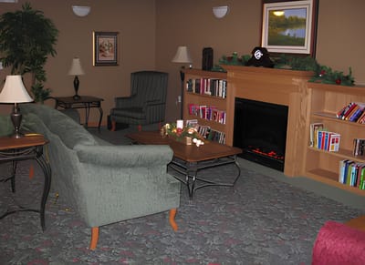 Cozy lounge area with seating and bookshelves
