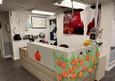 Front desk area decorated for Halloween with ghost decorations