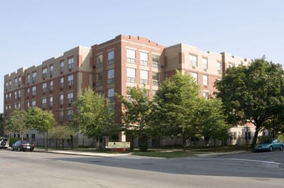 Exterior view of a senior living facility with trees