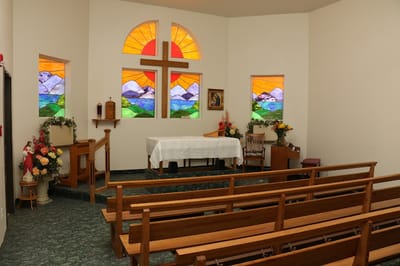 Interior view of a chapel with stained glass windows