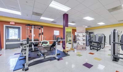 Gym area with fitness equipment in a brightly colored room