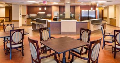 Common area with tables and chairs in a facility