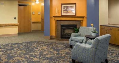A cozy common area with seating and a fireplace