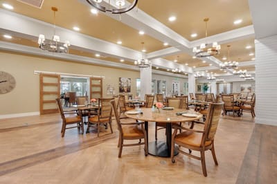 Bright dining room with multiple tables and chairs