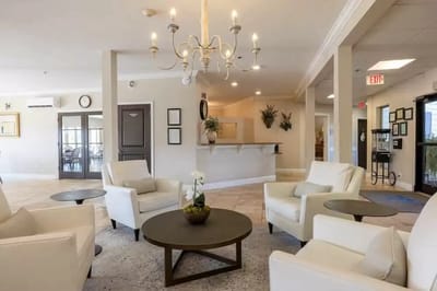 Bright common area with seating and chandelier