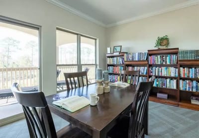 Bright common area with bookshelves and a table
