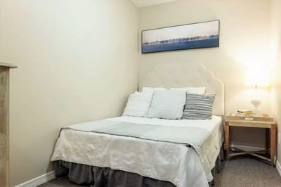 Cozy bedroom with a bed and bedside lamp
