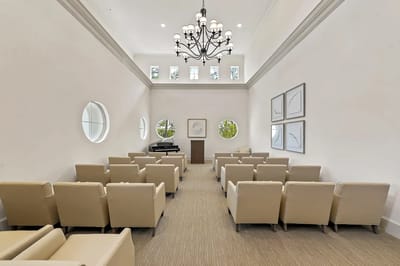 Bright interior common area with seating and piano