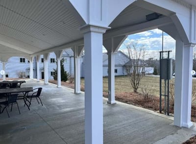 Covered outdoor seating area with views of the lawn