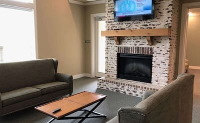 Lounge area with sofa and fireplace