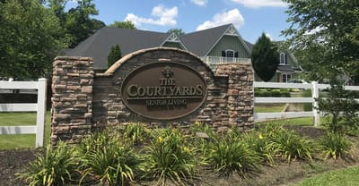 Sign for The Courtyards Senior Living facility outdoors
