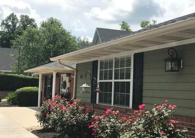 Exterior view of a senior living facility with flowers