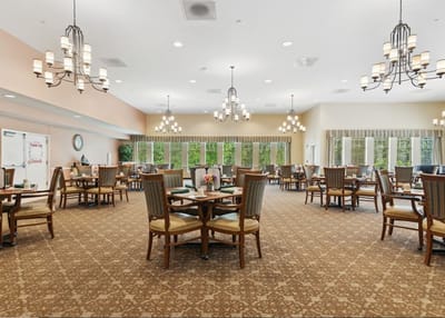 Dining area with tables and chairs in warm lighting