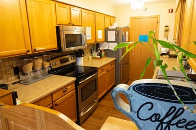 Bright kitchen area with wooden cabinets and appliances