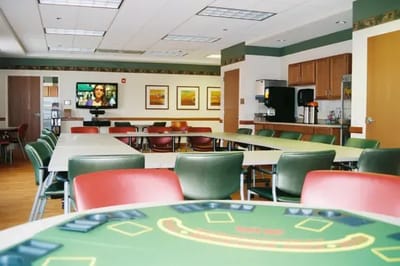 Interior view of a common area with tables and a TV