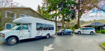 Facility vehicles parked in front of the building