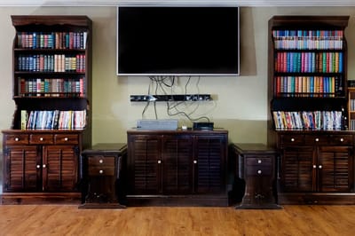 Interior of a common area with bookshelves and a TV