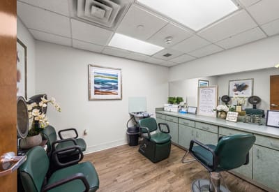 Hair salon area with styling chairs and mirrors