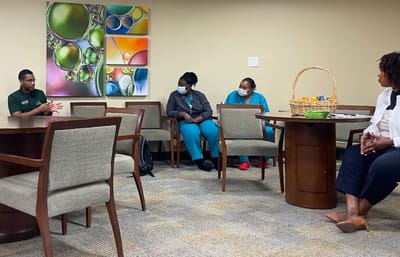 Staff members engaged in a discussion around a table