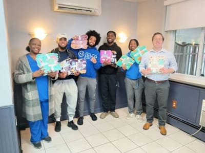 Residents and volunteers holding colorful crafts during an activity day.